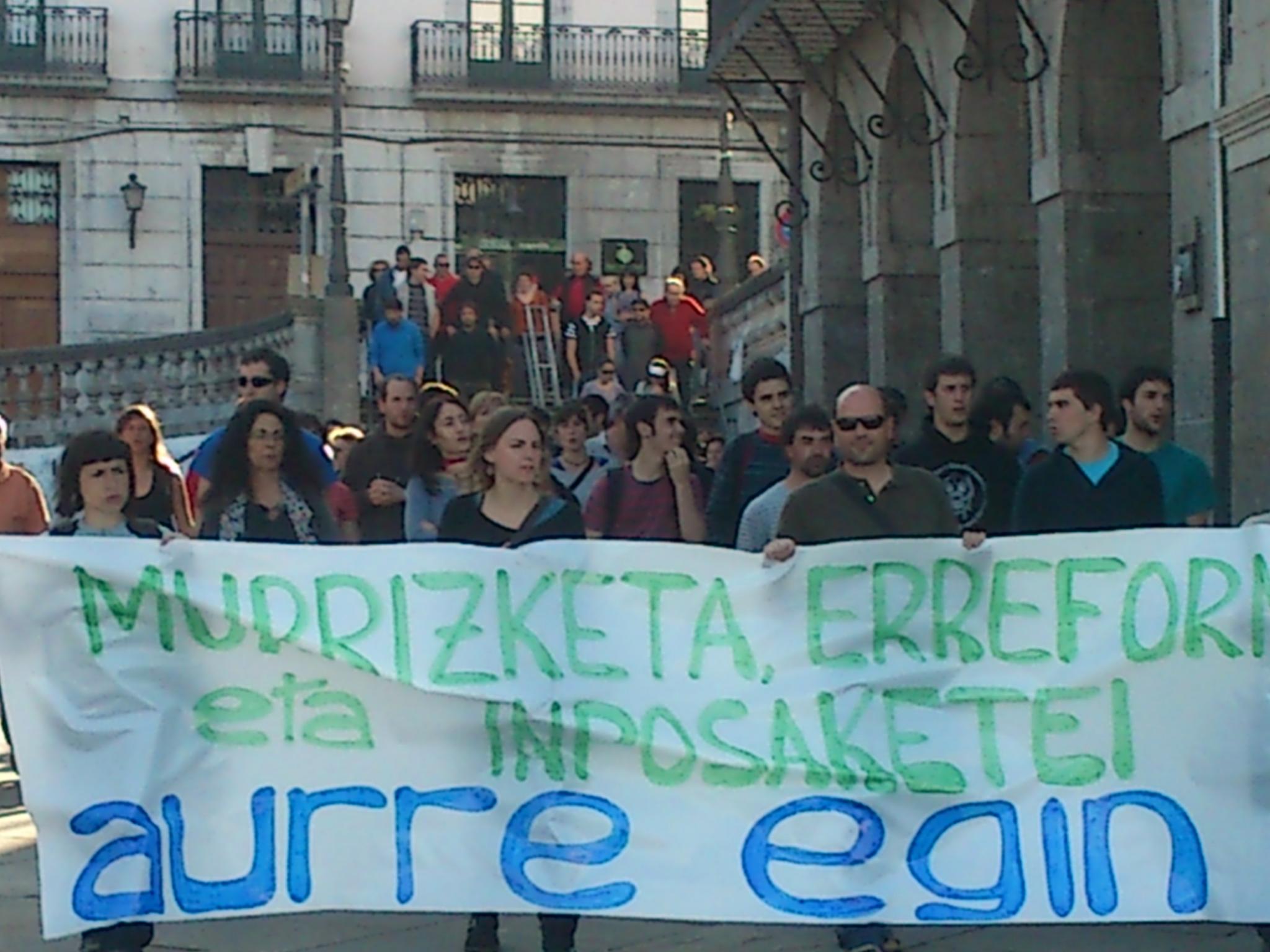 people walking down the street while holding up signs