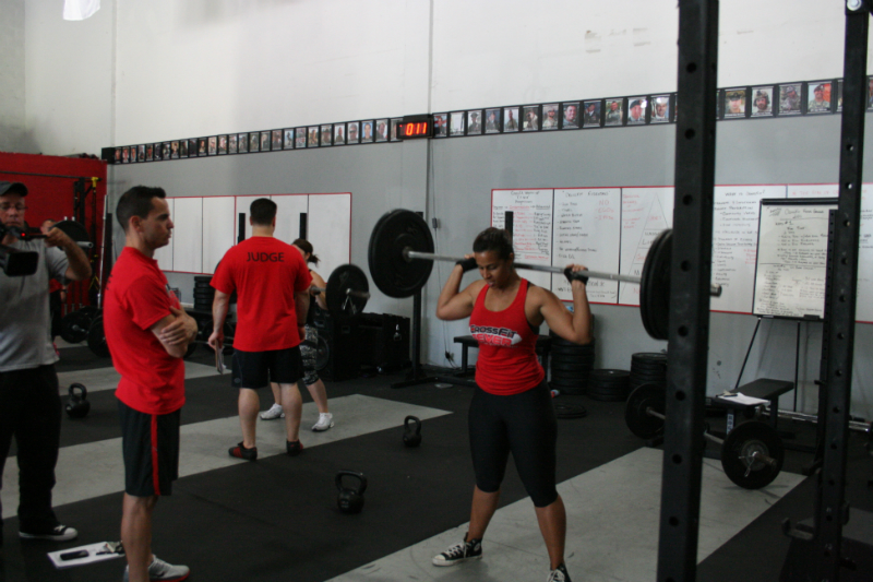 people exercising and doing various activities in a gym