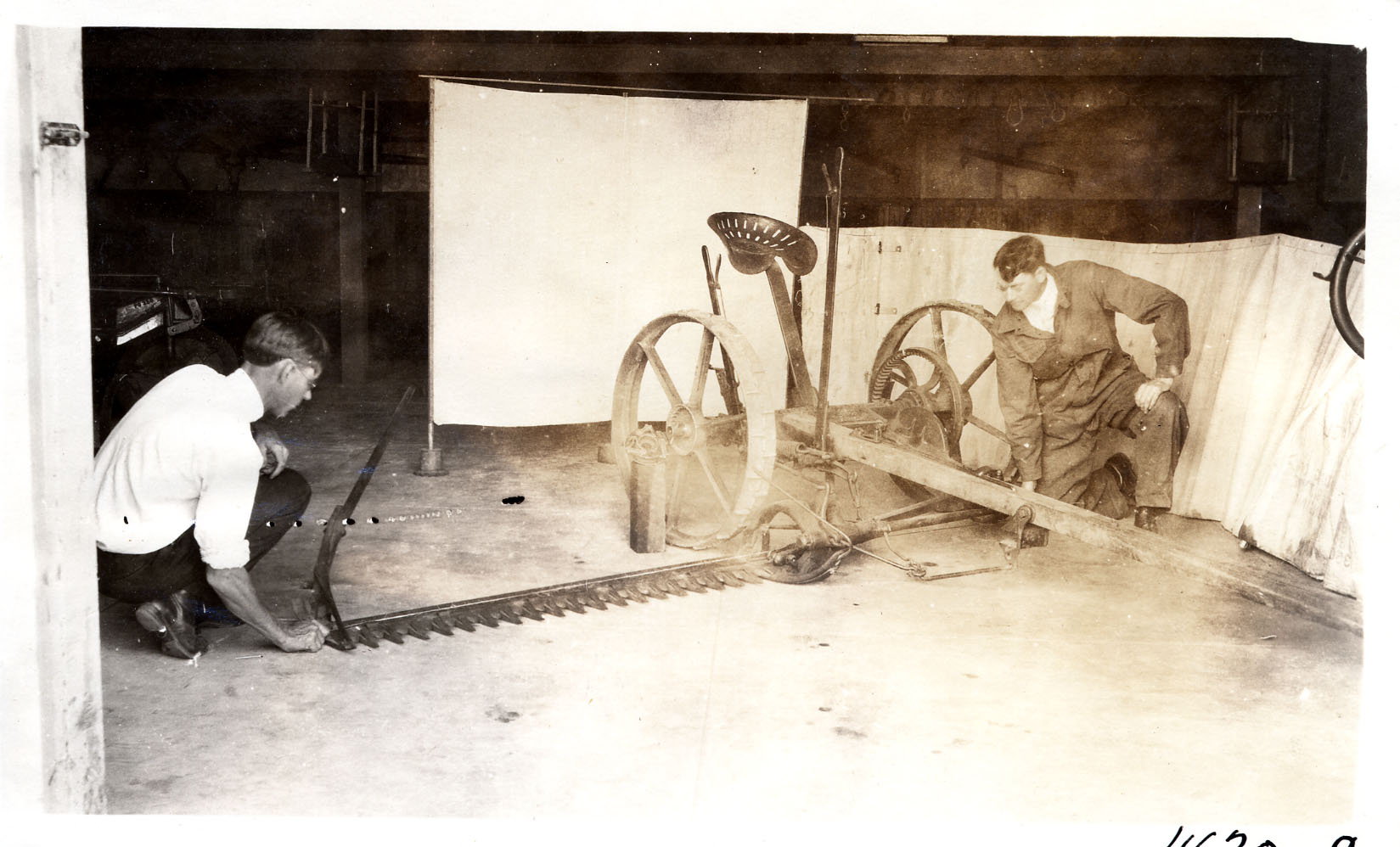 the two men work on their new bicycle in the shop