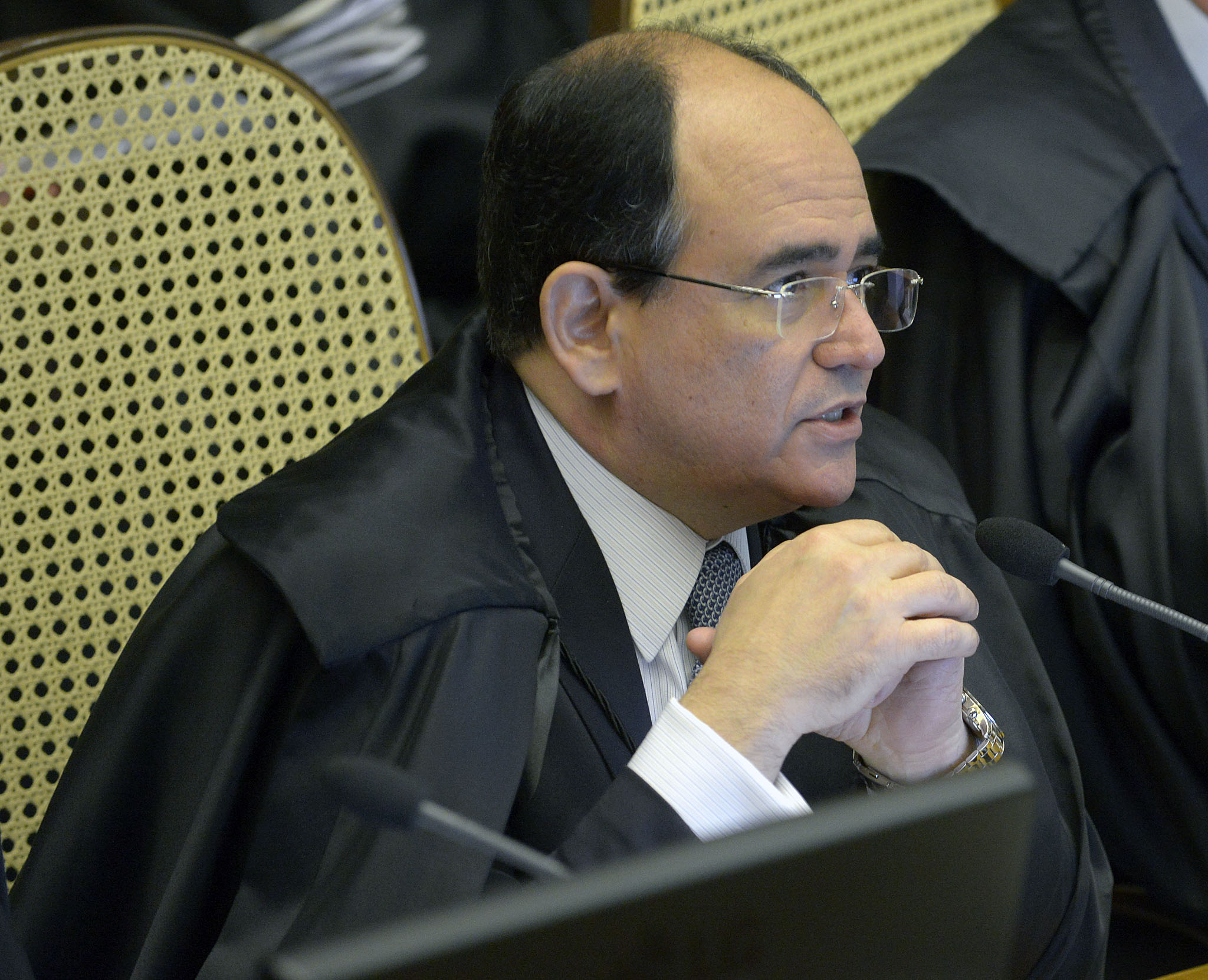 a judge looking away from the camera at a meeting