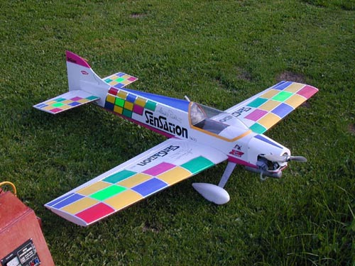 an upside down toy plane in the grass