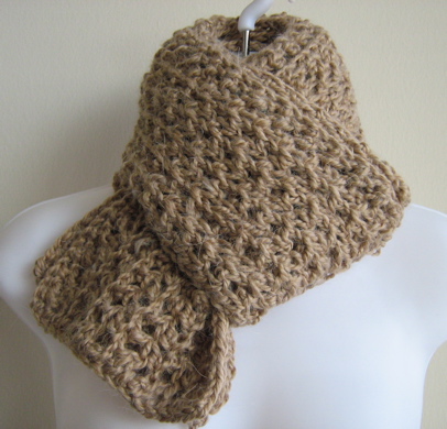a knit scarf with an odd shaped design on it