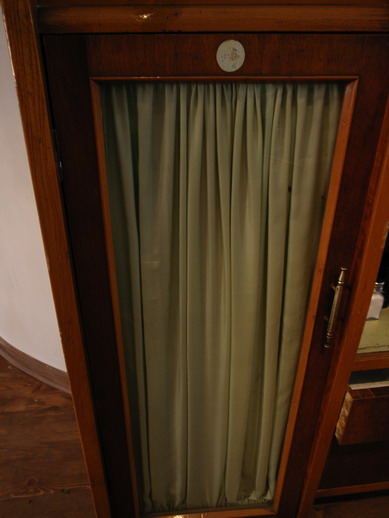 a close up of an open wooden door with curtains