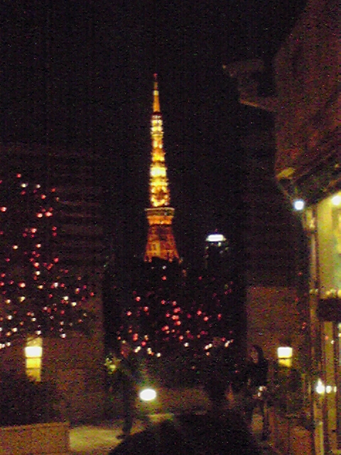 a city with lights and buildings and streetlights at night