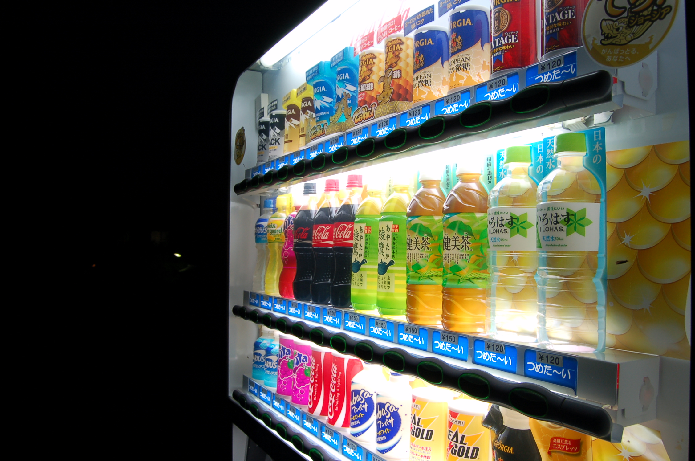 an alcove of soft drinks in different colors and flavors