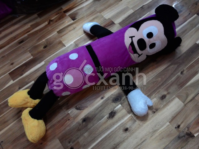 a mickey mouse stuffed animal laying on the floor