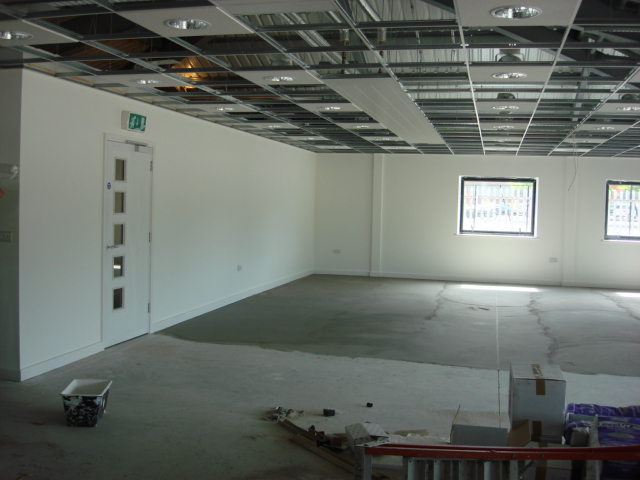 an empty room with white walls, and multiple windows