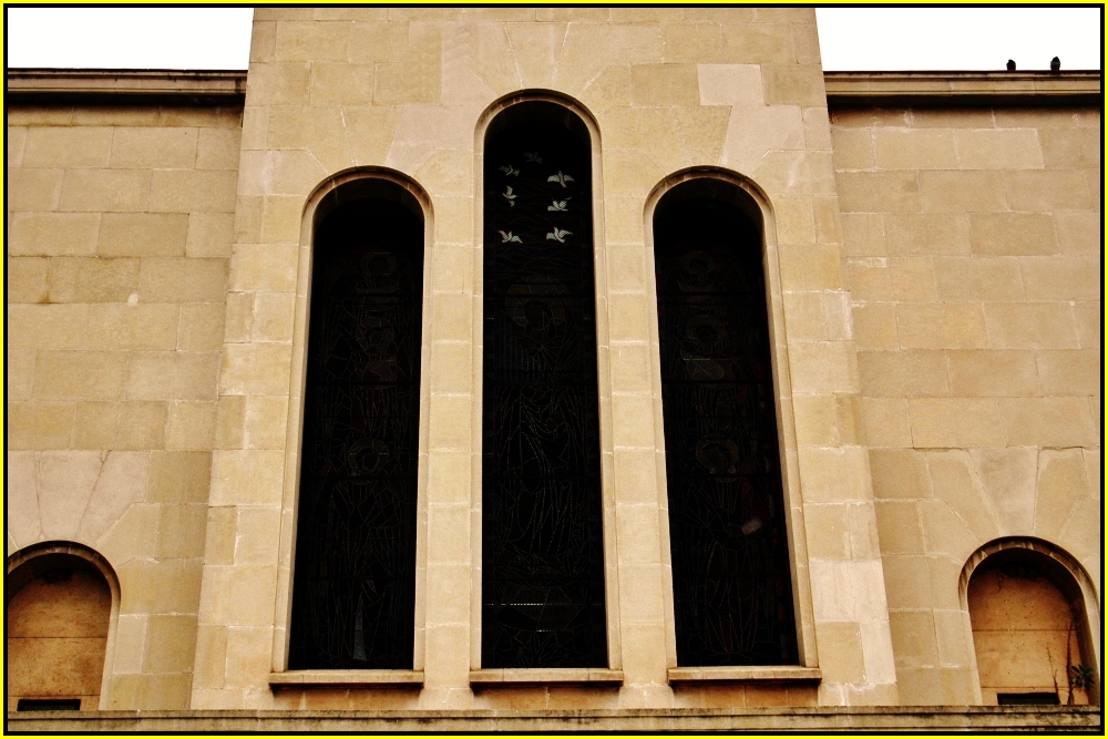 the front view of a building with two tall windows