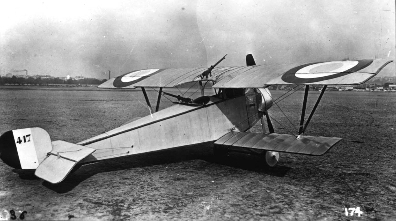 a old biplane is sitting in the open field