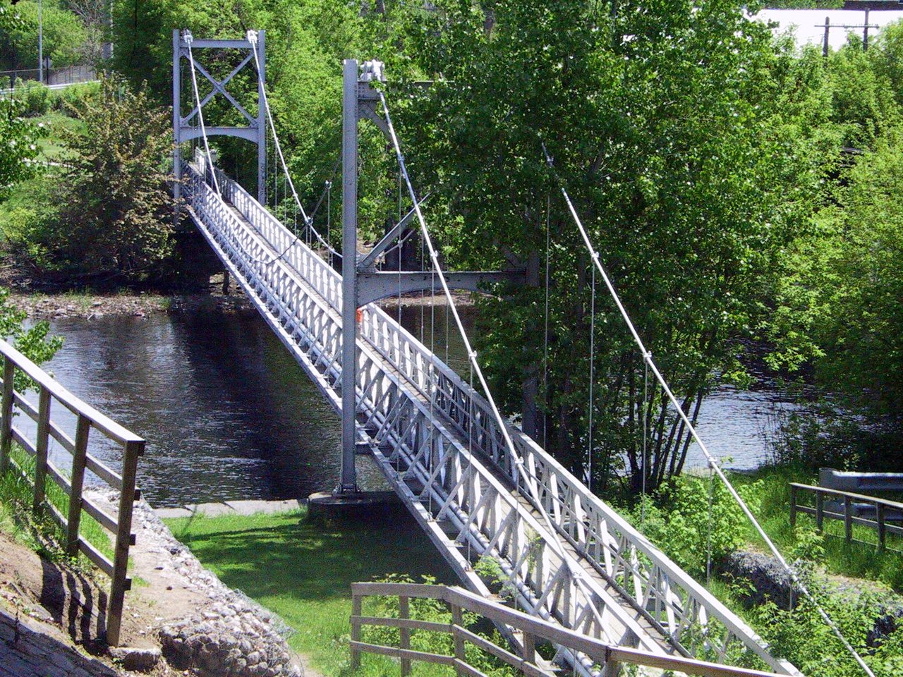 a bridge going over a body of water next to trees