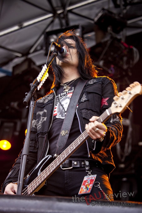 a male with black hair playing a bass