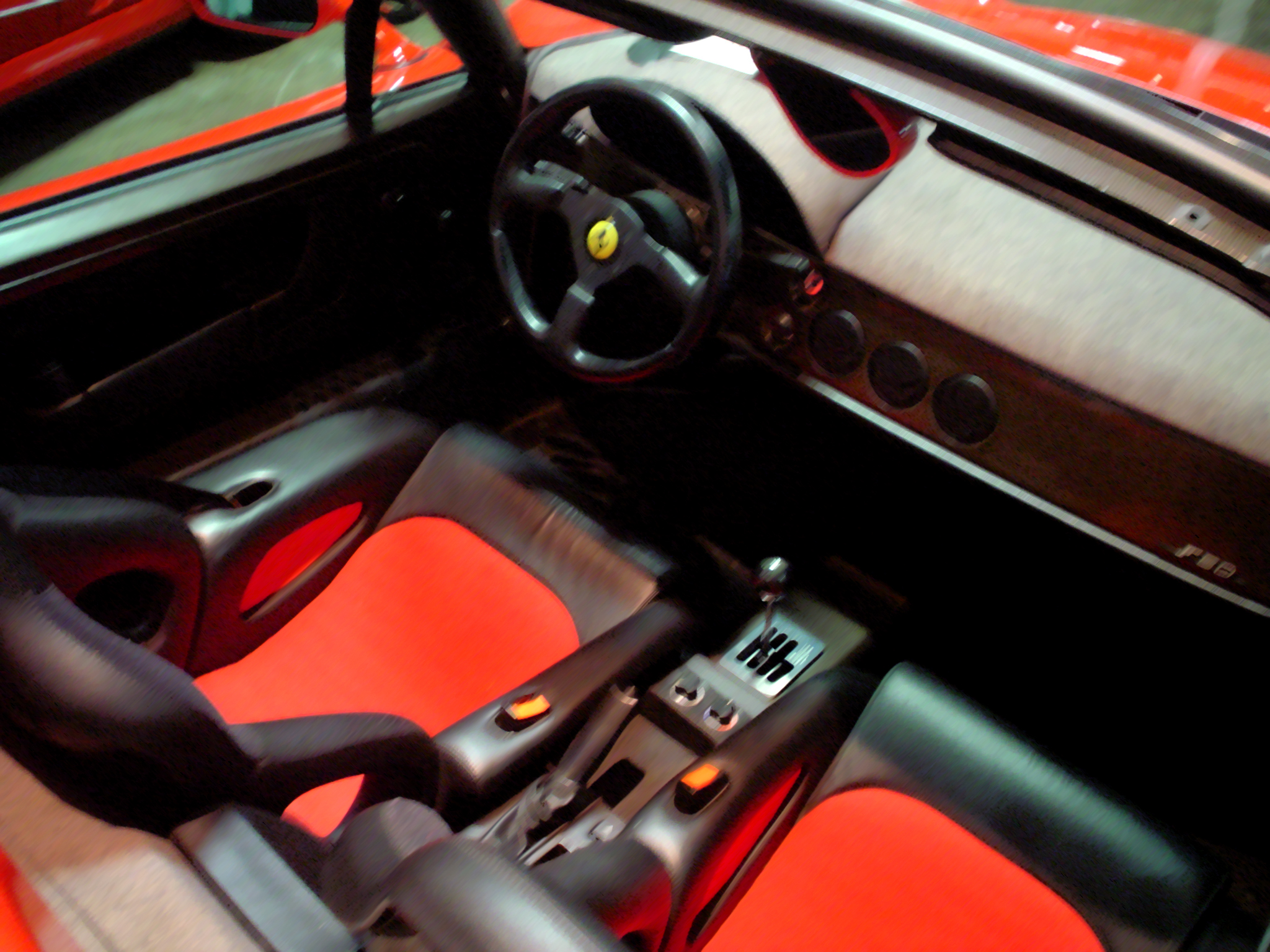 the inside of a car with an illuminated floor and red interior