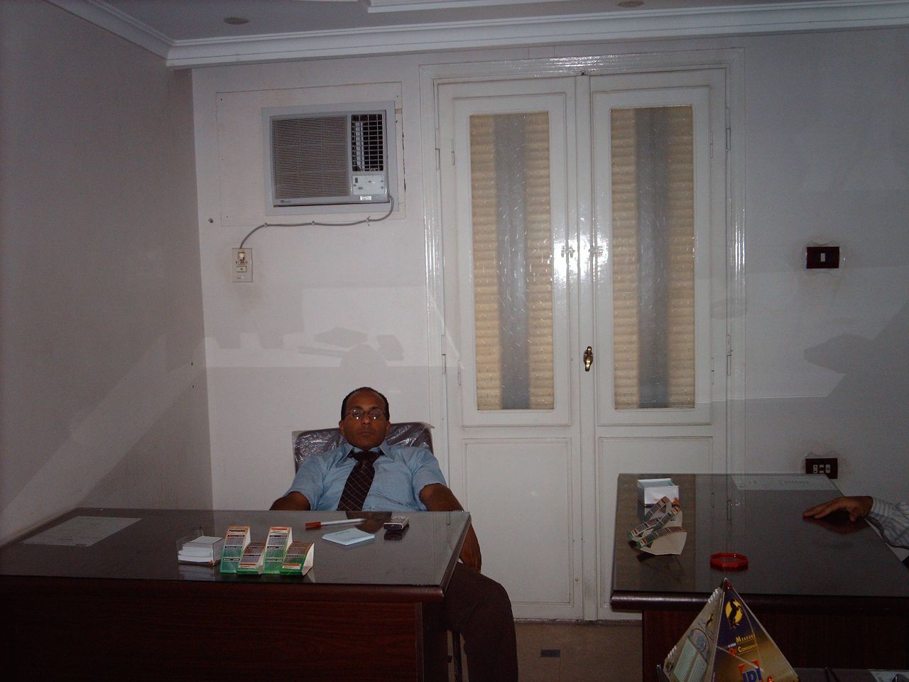 a man is sitting at a desk working on a computer