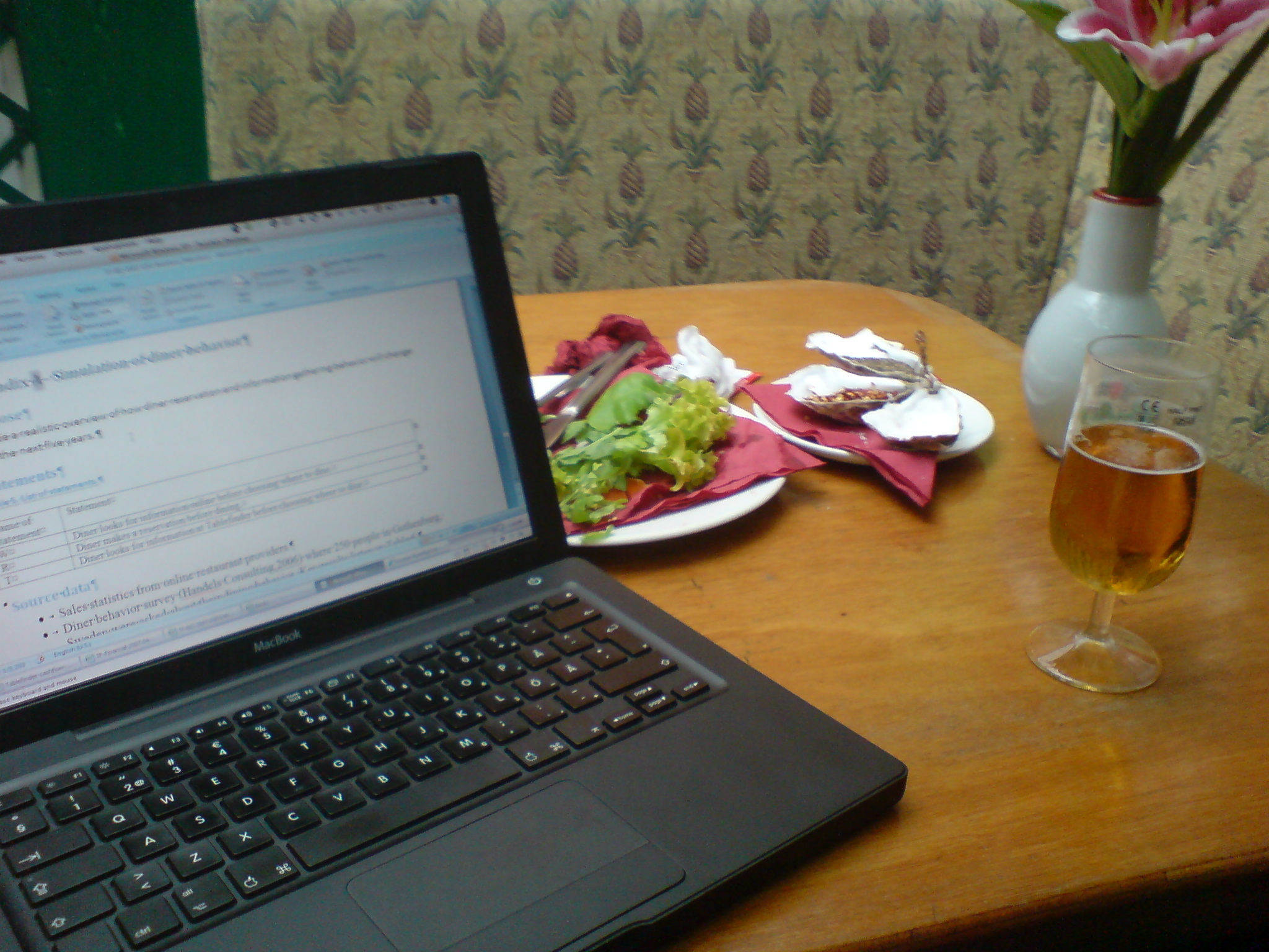 a laptop computer sitting on top of a wooden table