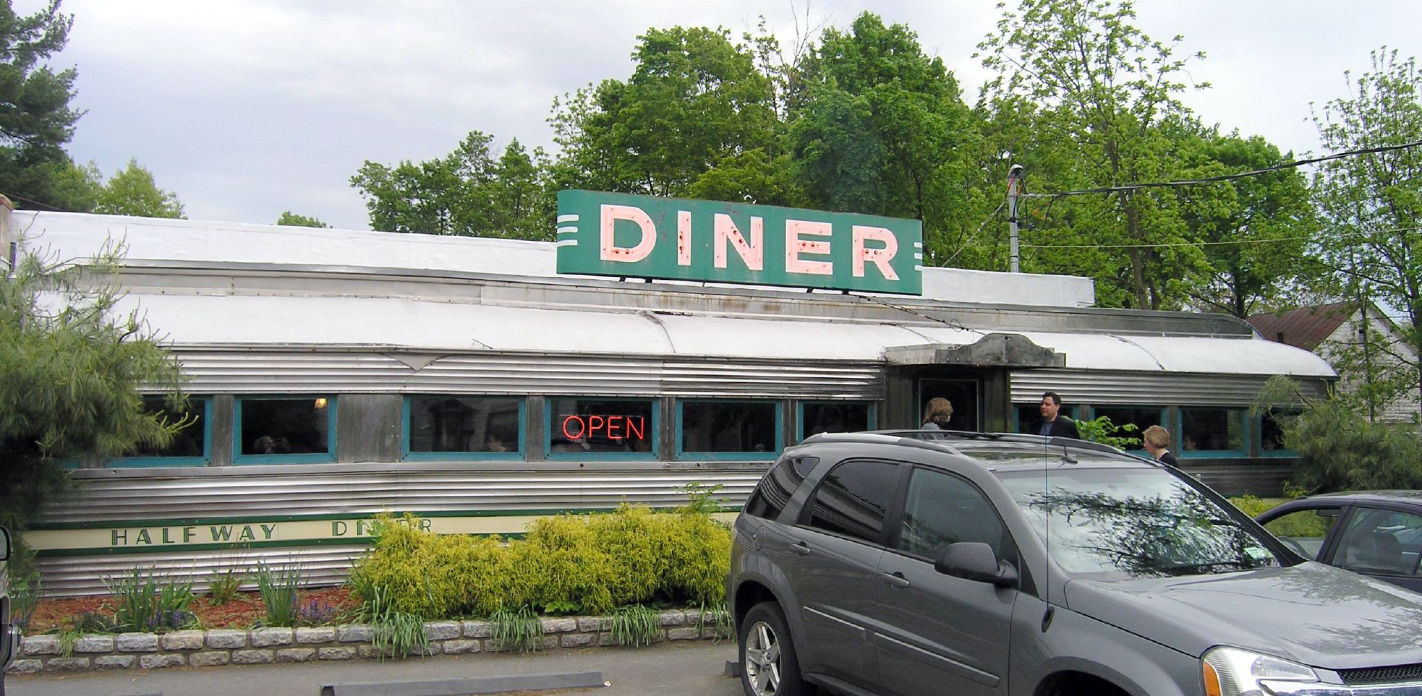 a diner with car parked outside it