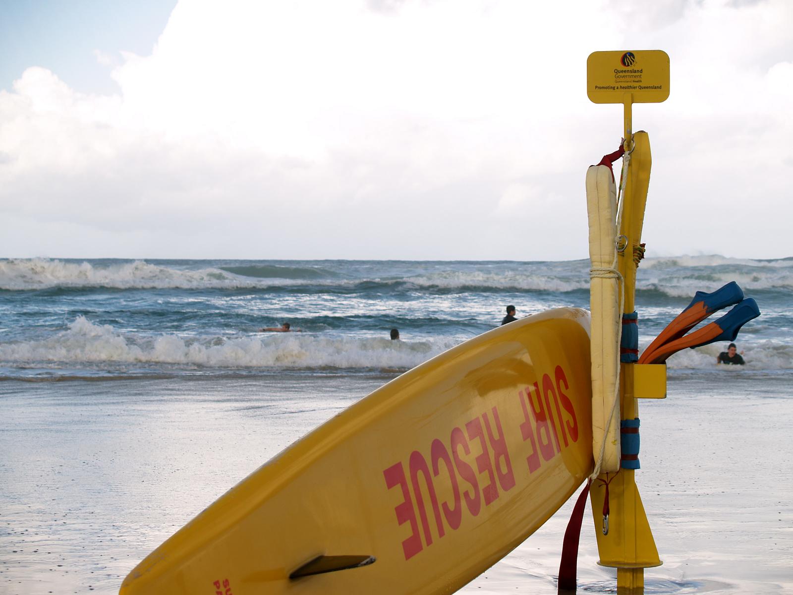 a life preserve sign is leaning on a surfboard