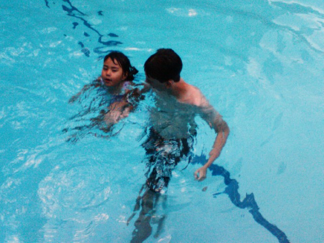 two s swimming in the pool with  on