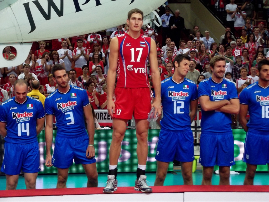 a man standing on the floor between his team members