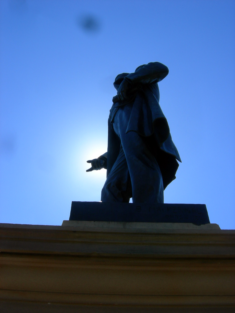 the silhouette of a person standing on top of a building