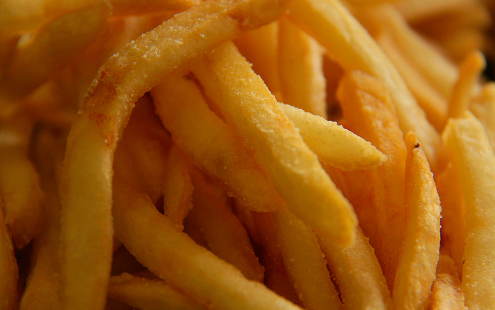 close up of a pile of fries with water droplets