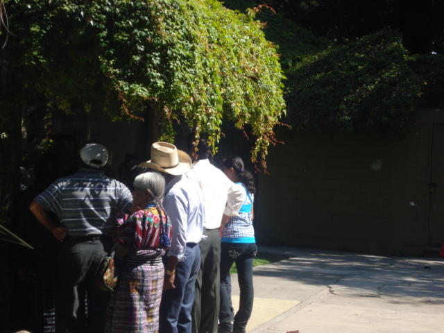 many people wait on the sidewalk for their turn