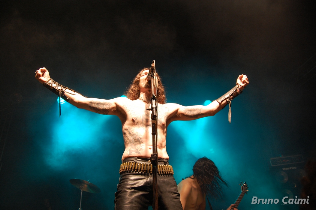 a shirtless male is on stage during a concert