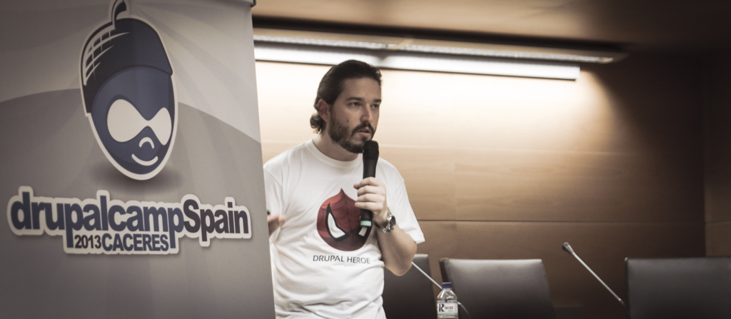 a man with a microphone stands by a sign