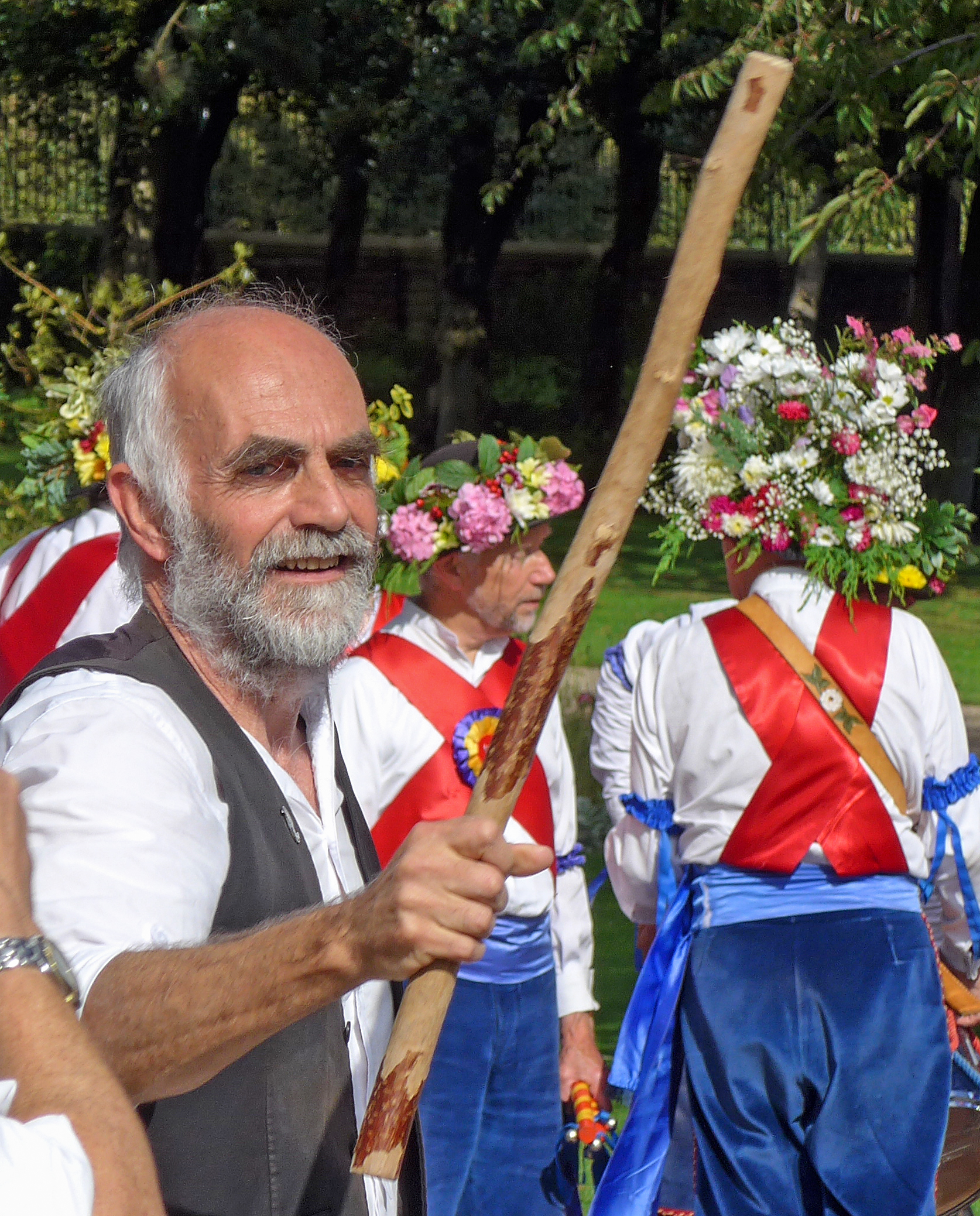a group of men dressed in medieval clothing carrying flags