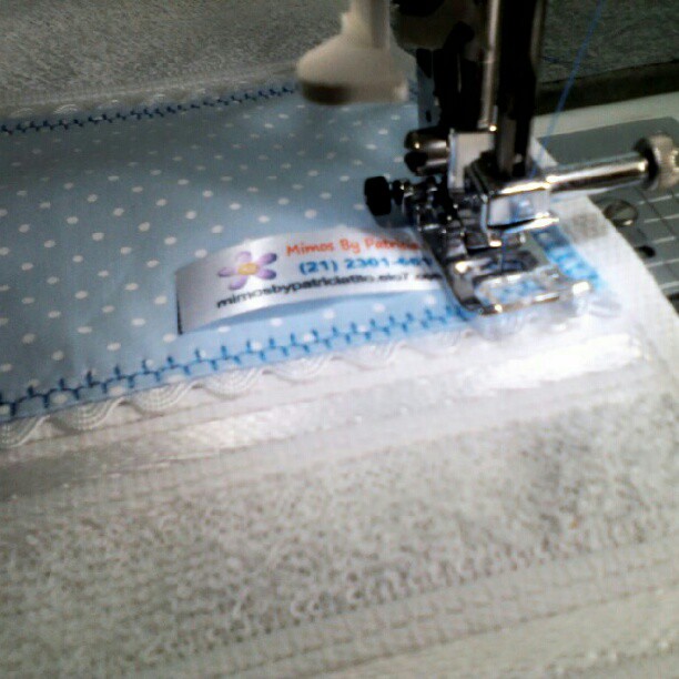 an embroidered cloth sits in front of a machine