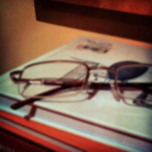 some reading glasses sitting on top of a book