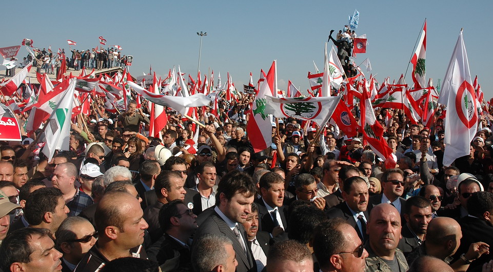 a crowd is all gathered together, with many people holding their national flags