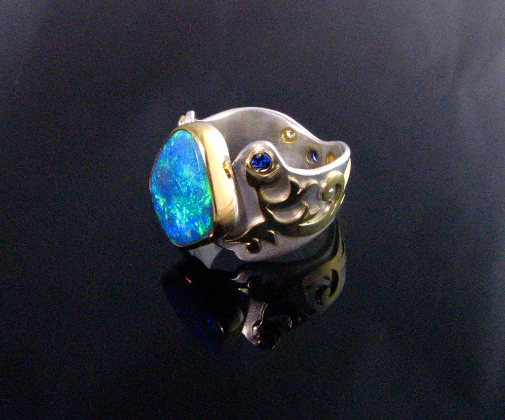 a blue stone in a silver and gold band ring