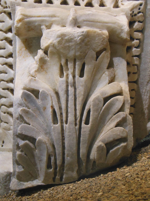 an ancient wall relief with leaves and flowers