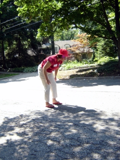 woman wearing pink hat and white pants is on skateboard