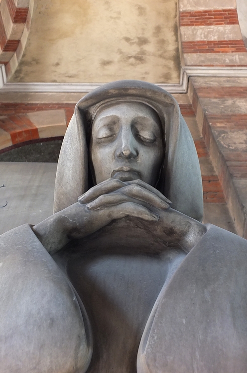 a statue of a person with their hands on their face