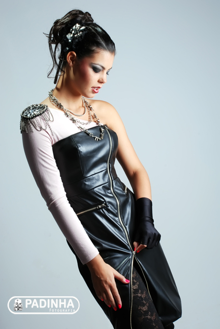 a women in a dress and glove is posing