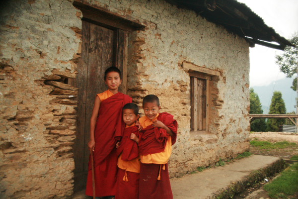 two boys and their friend standing outside a building