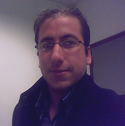 a man in glasses poses for the camera