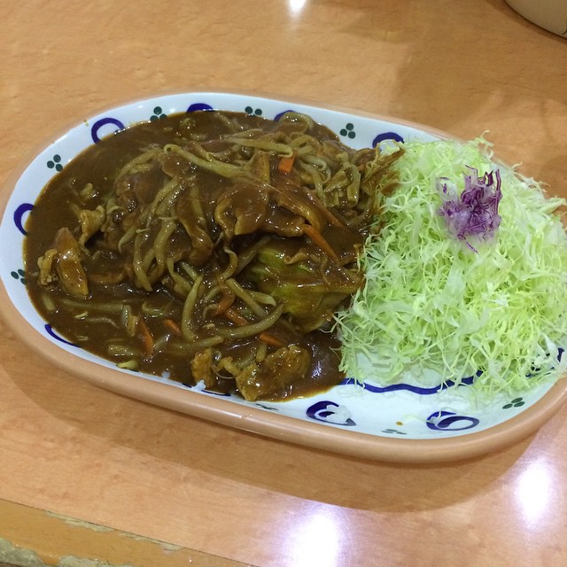a dish with cabbage, rice and a sauce