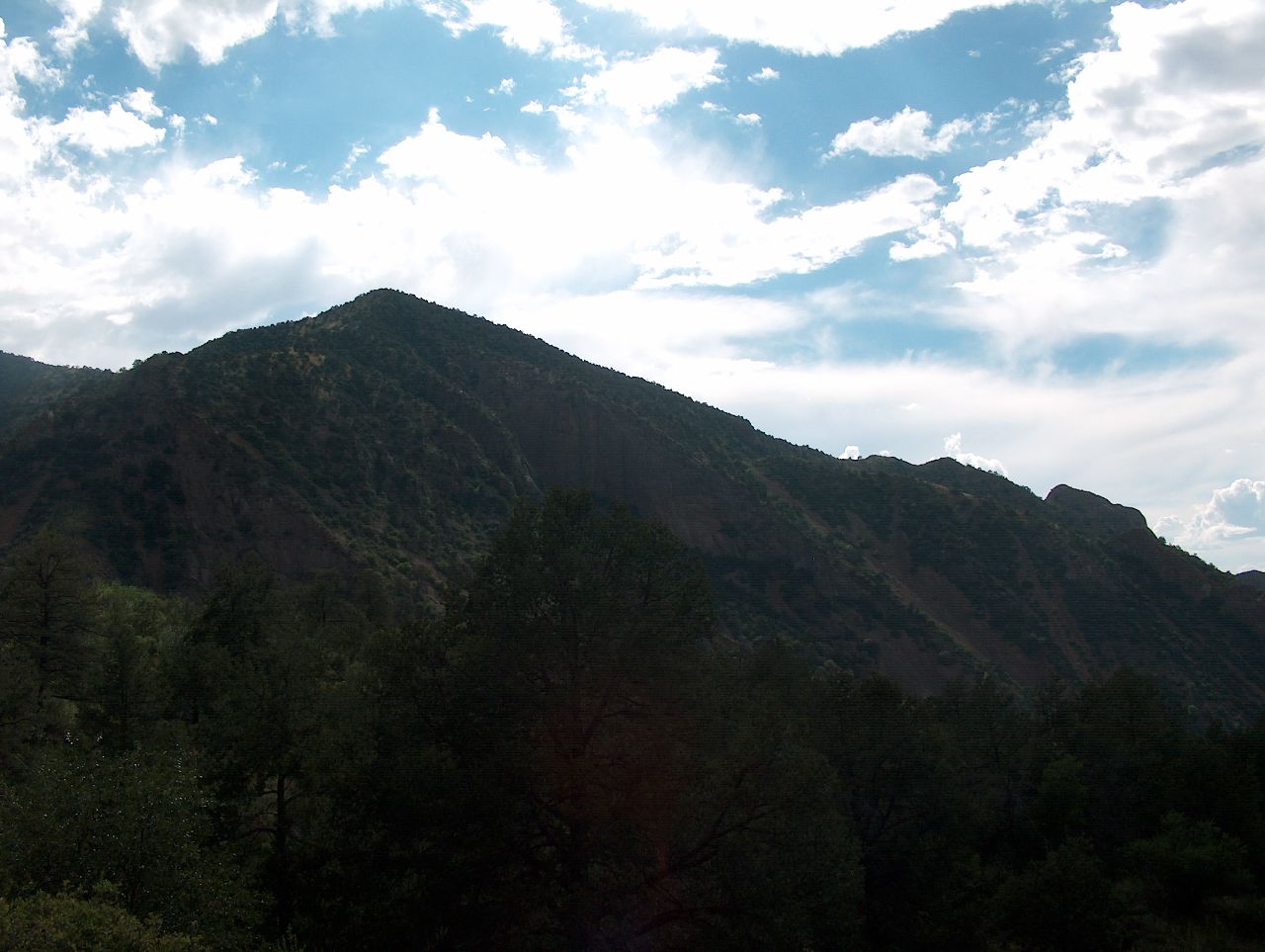 the green mountains range are surrounded by trees