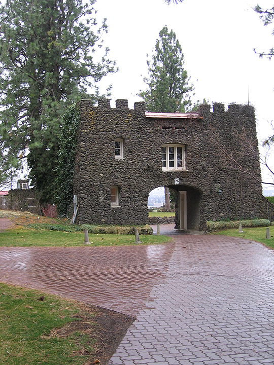 a stone tower has a gate to the front