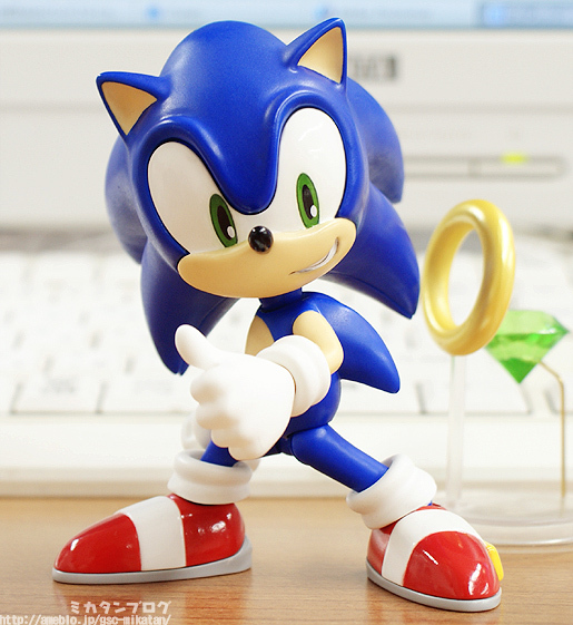 a toy sonic character standing in front of a keyboard