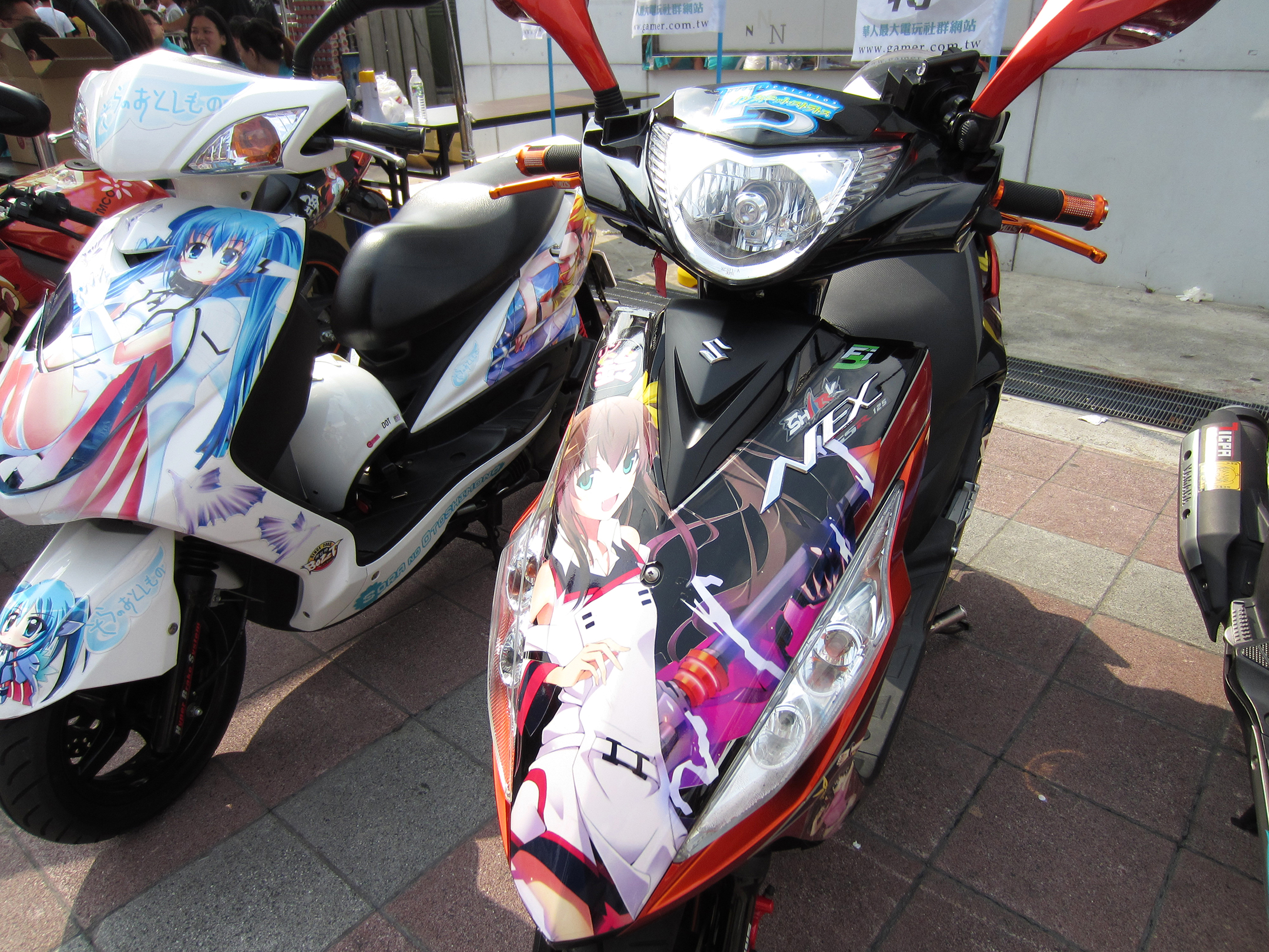 two motorcycles are painted with colorful designs on them