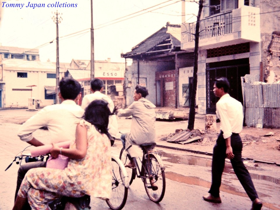 people walking, riding and hing a bicycle