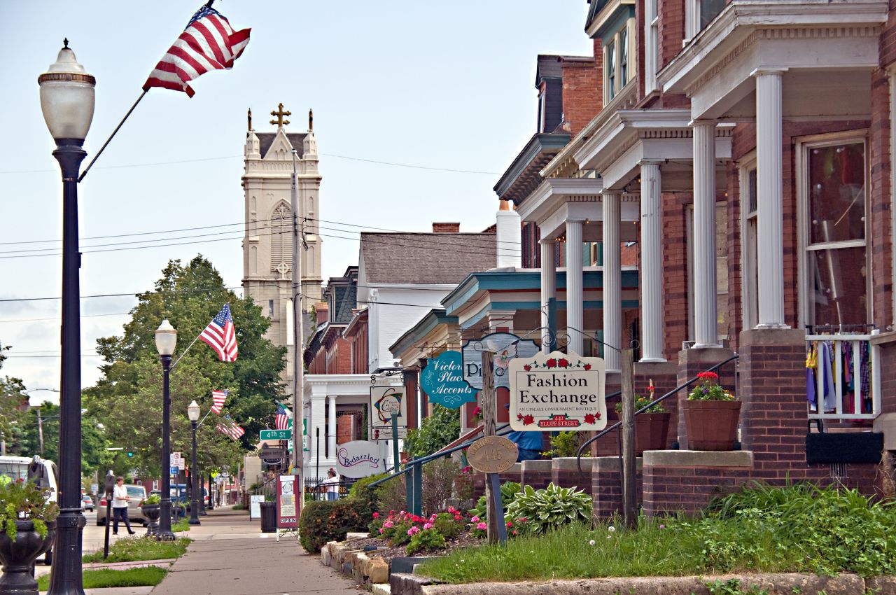 a street with a small church tower and an american flag