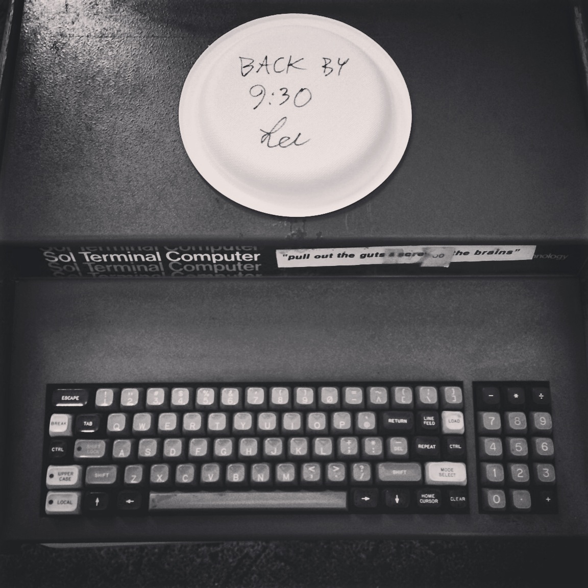 a black and white po of a keyboard and a disk