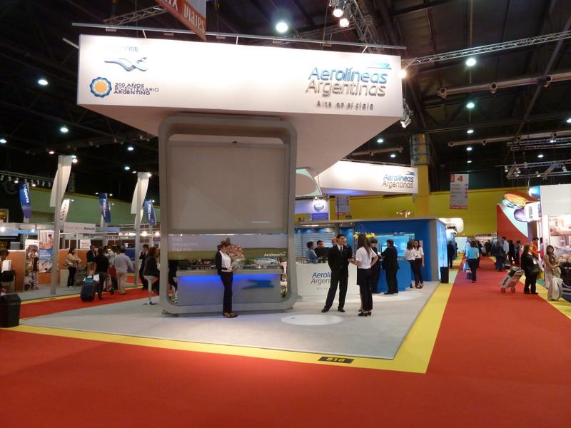 a crowd of people stand at a trade show