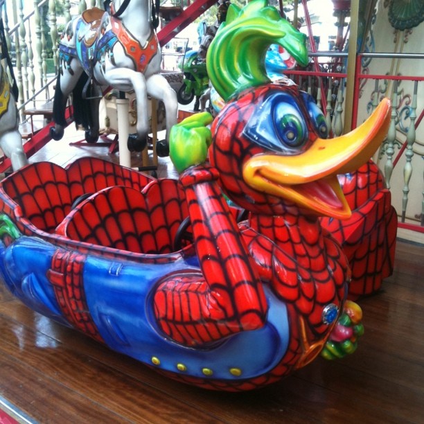 an elaborate carousel with colorful sculptures and horses