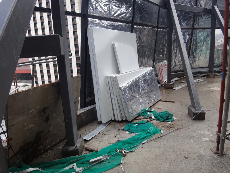 several white appliances sitting in a construction area with a ladder