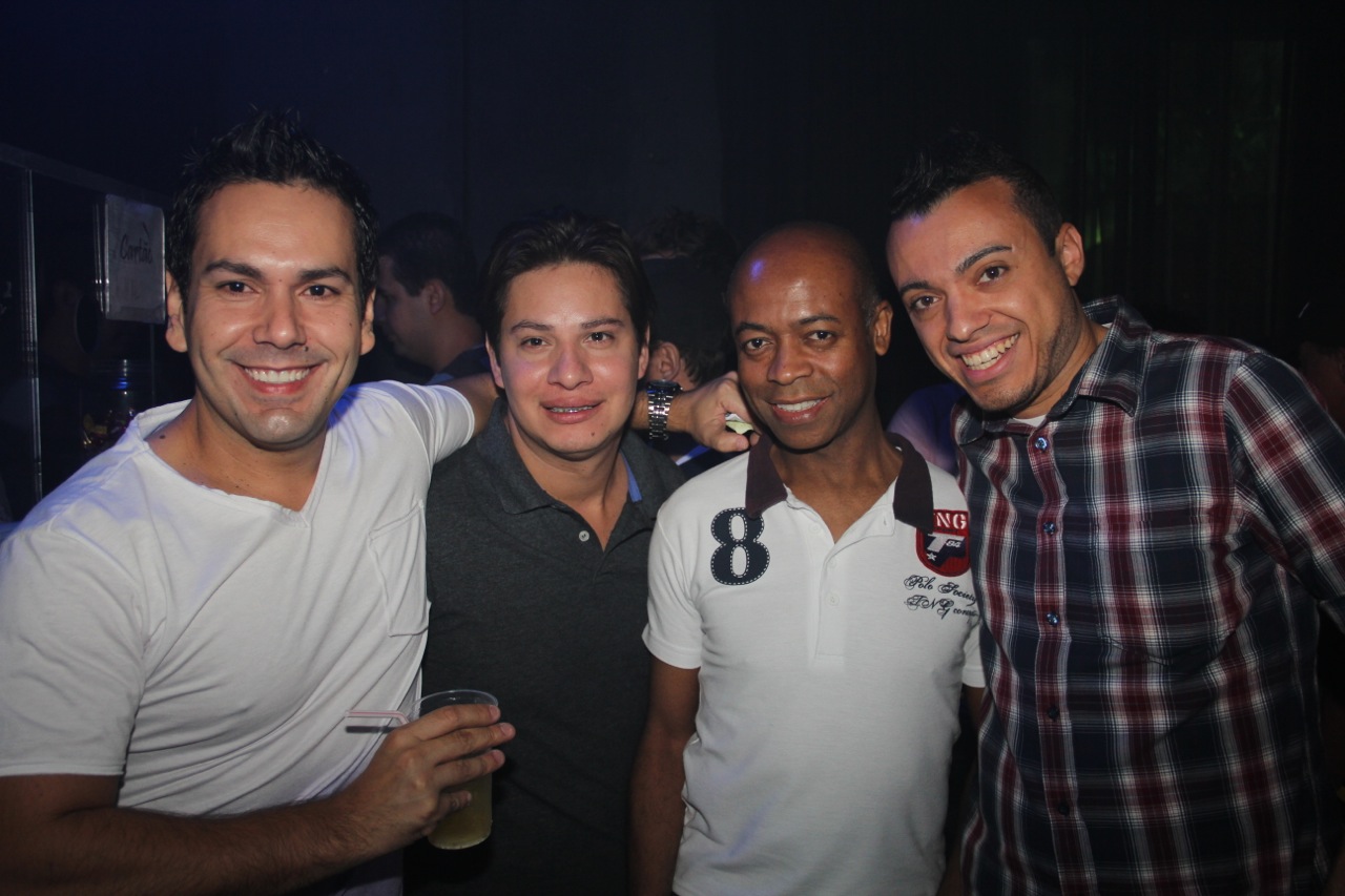 four men are posing for the camera together at a party